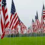A green field with American flags.