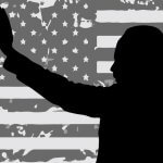 Silhouette of Martin Luther King Jr. on an American flag.