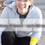 Student wearing gloves picks up trash