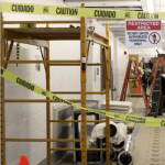 photo of construction with scaffolding and caution tape