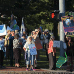 a crowd of individuals with signs protesting climate change