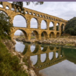 old style bridgee with supporting arches across a river