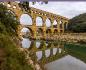 old style bridgee with supporting arches across a river