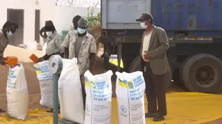 Workers prepare bags of food aid for distribution by the World Food Programme, part of the 'Grains from Ukraine' initiative backed by the EU and the US. in a warehouse in Nouakchott, Mauritania, on November 19, 2024.