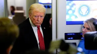 Trump speaks to the media aboard Air Force One.