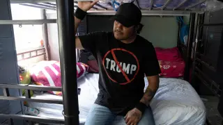 A Mexican migrant, recently deported after being detained in a US Immigration and Customs Enforcement (ICE) raid, sits on a bed at an LGBTQ+ shelter in Tijuana, Mexico, on July 30, 2025.