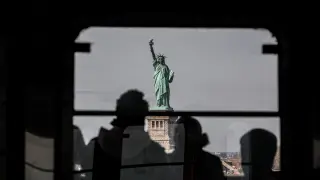 The Statue of Liberty is seen from the Staten Island Ferry in New York City.