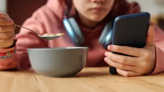 File image of a minor with a cell phone.