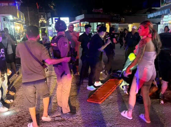 An image collage containing 1 images, Image 1 shows Paramedics and police attend to a victim on a street at night