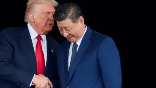 Donald Trump and Xi Jinping talk as they leave a bilateral meeting at Gimhae International Airport on the sidelines of the APEC summit in Busan, South Korea.