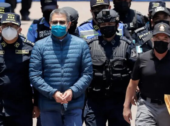 Former Honduran president Juan Orlando Hernández guarded by police in Honduras