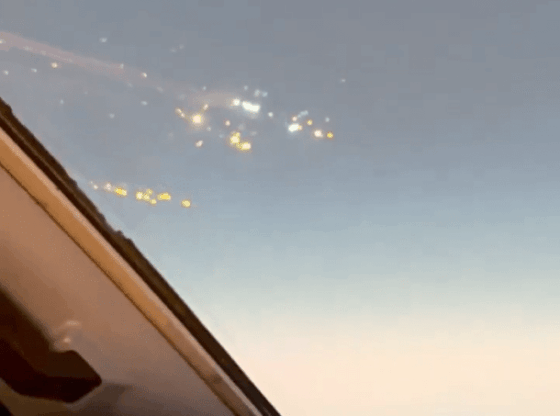 Airplane view of city lights at night.