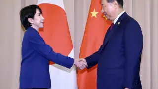 Japanese Prime Minister Sanae Takaichi shakes hands with Chinese President Xi Jinping before their talks in Gyeongju, South Korea.